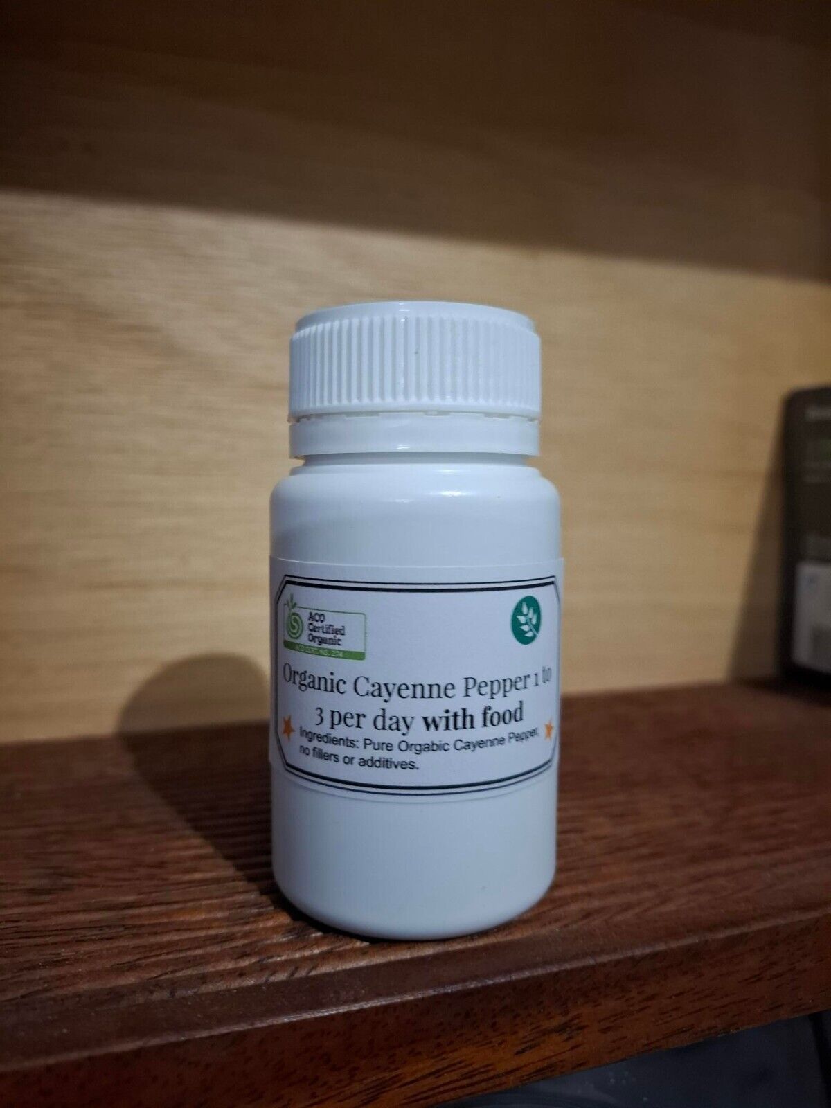 Organic cayenne pepper capsules in a bottle